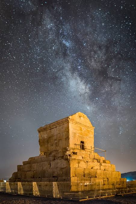 Tomb of Cyrus the Great at Pasargadae beneath a Milky Way sky — six-stepped limestone burial chamber on the Morghab plain, Fars Province, Iran, c. 530 BCE