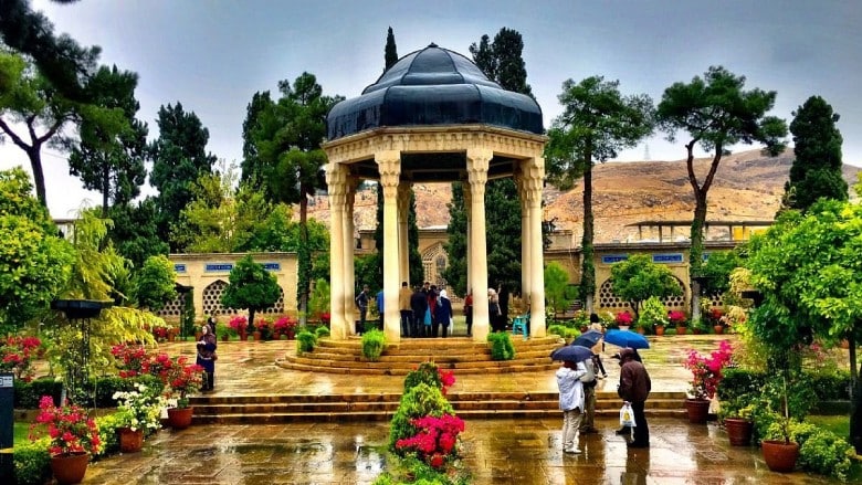 Hafezieh — the mausoleum of Hafez in Shiraz at dusk, surrounded by roses and cypress